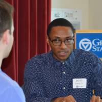An alumnus explaining something to a student at the 30 Minute Mentors Event